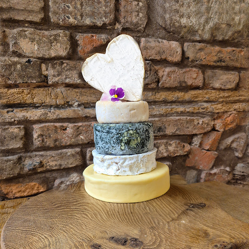 500g cheddar on the base of the basic Ronnie stack with a brie heart on top which includes 5 cheeses  in a lovely 4.2kg party cake from Mousetrap Cheese